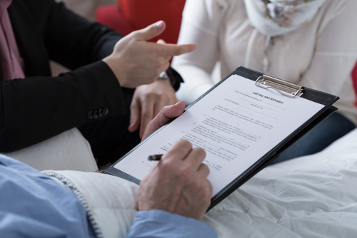 Close Up Of Older Sick Man Holding His Last Will And Close Up Of Older Sick Man Holding His Last Will And