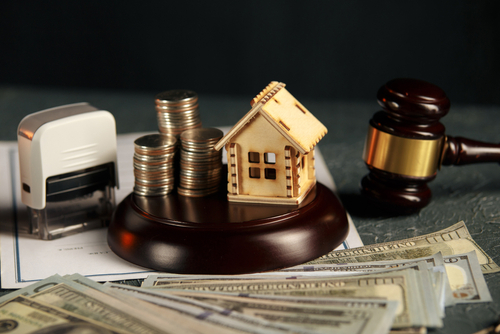 A Row Of Coins On A Small House Model And A Row Of Coins On A Small House Model And