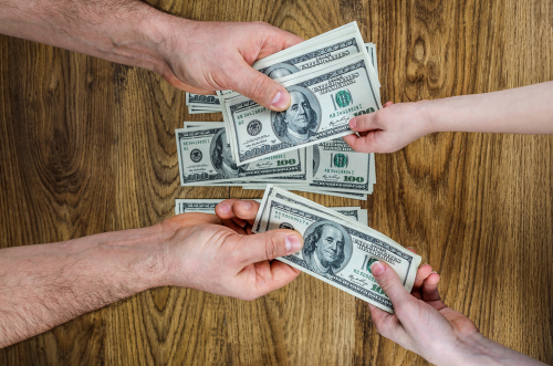 Men S Hands Stretch Out Money In The Form Of Hundred Dollar Men S Hands Stretch Out Money In The Form Of Hundred Dollar